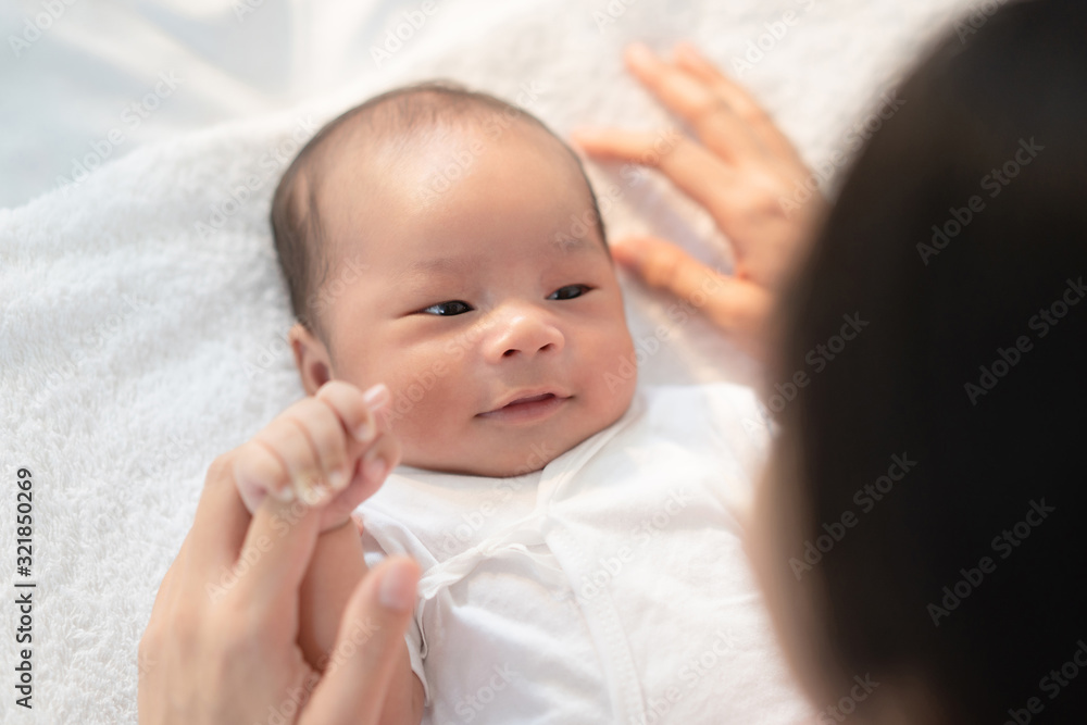 Newborn baby talking to mom hold the finger of mom