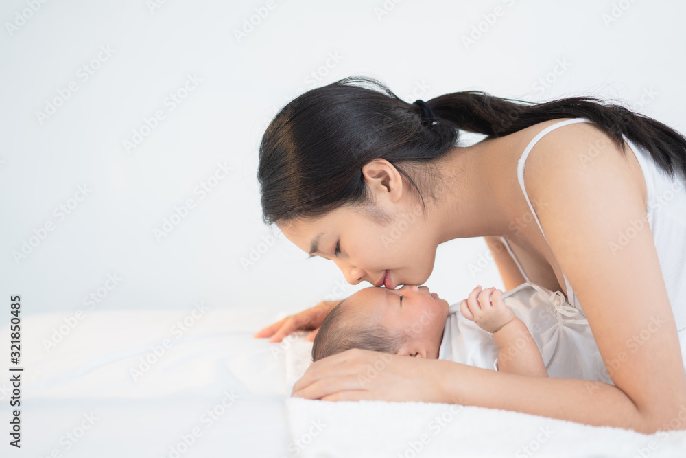 Mother kisses the babys forehead