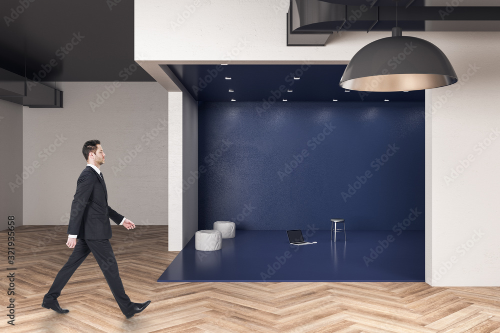 Businessman walking in blue office hall in futuristic interior.