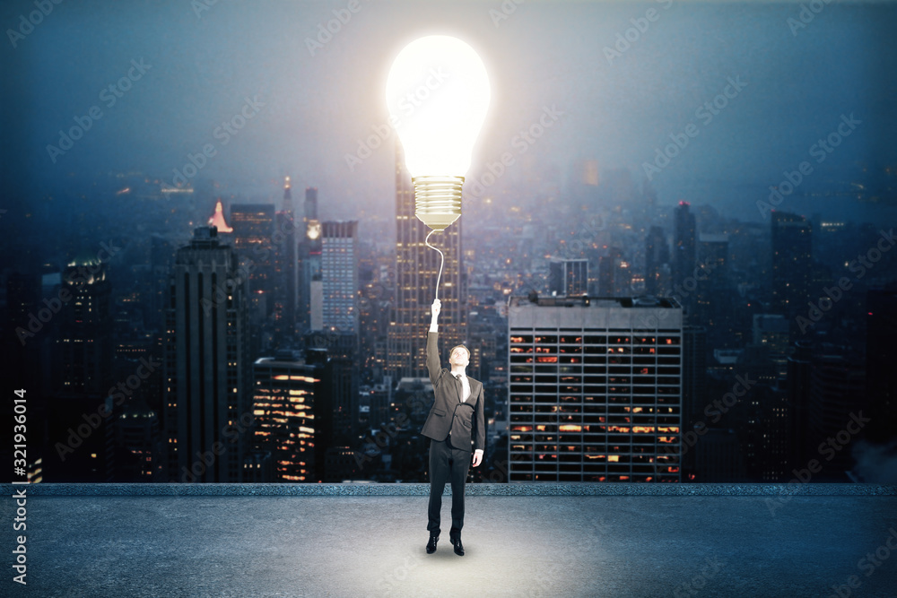 Businessman holding light bulb