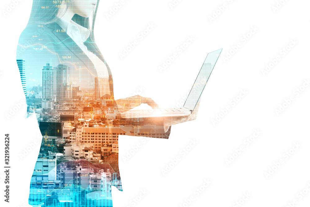 Businesswoman silhouette holding laptop on city background