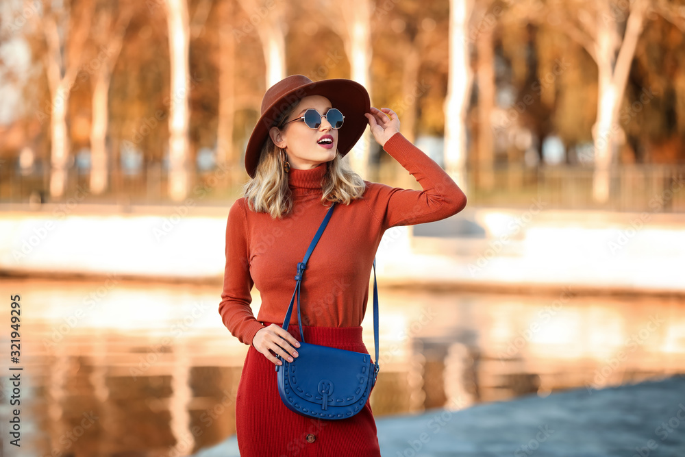 Portrait of fashionable young woman near river