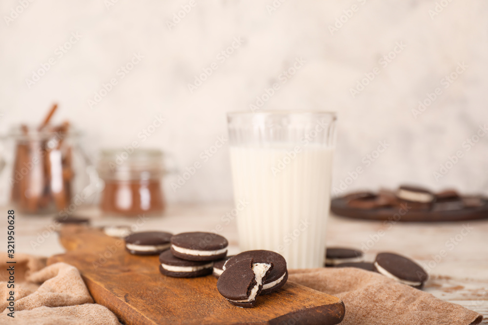 Tasty chocolate cookies with milk on white table