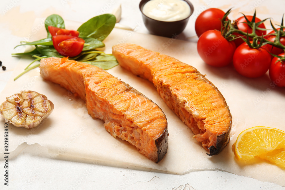 Tasty cooked salmon and sauce on white background