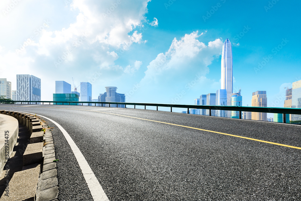 Empty asphalt road and urban commercial buildings in Shenzhen,China.