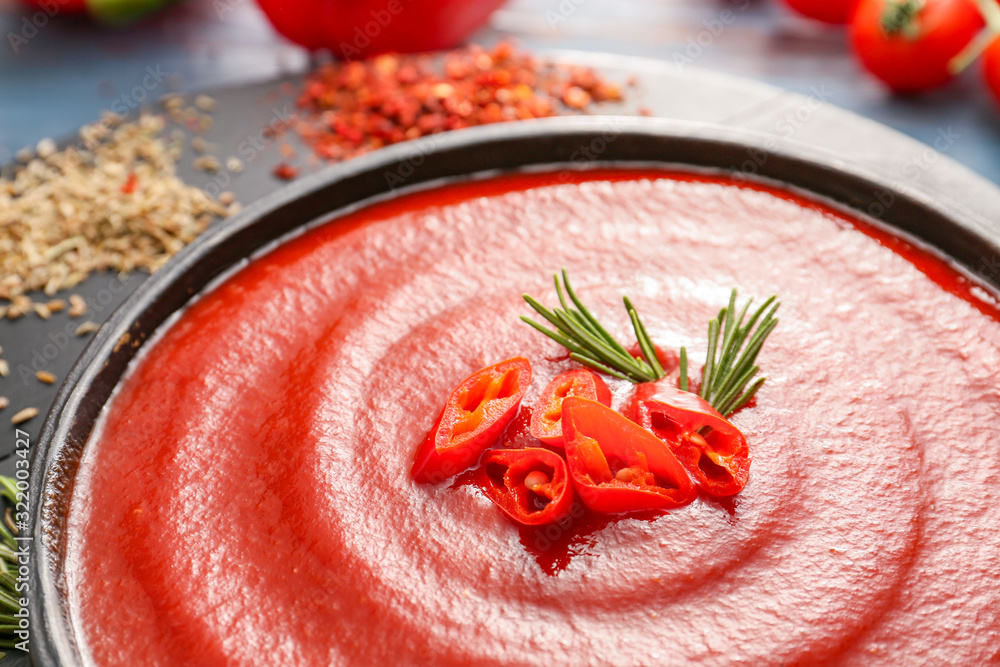 Pan with tomato sauce on table, closeup