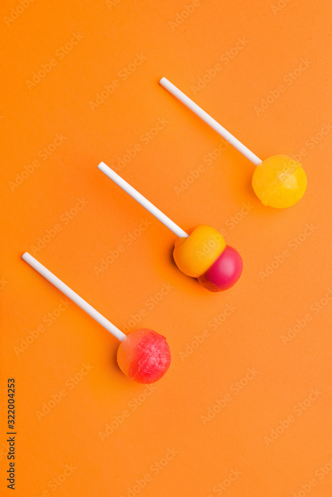 Tasty lollipops on color background