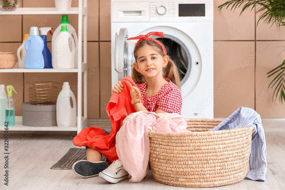 Little housewife with laundry at home