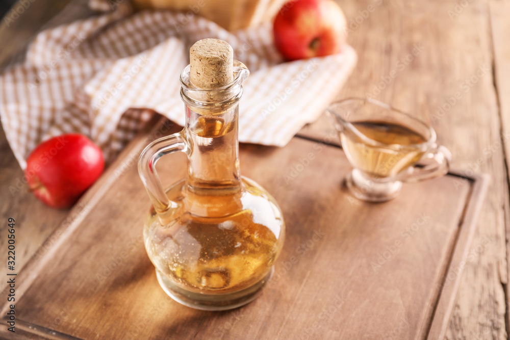 Apple cider vinegar on wooden table