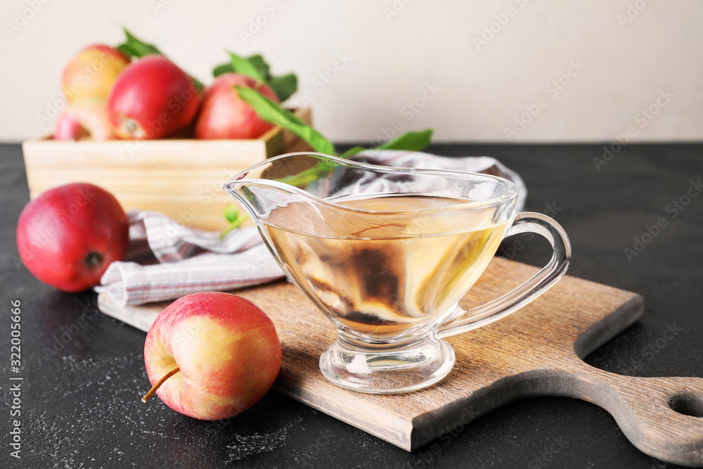 Gravy boat of apple cider vinegar on table