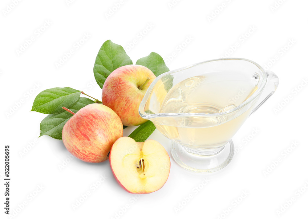 Gravy boat of apple cider vinegar on white background