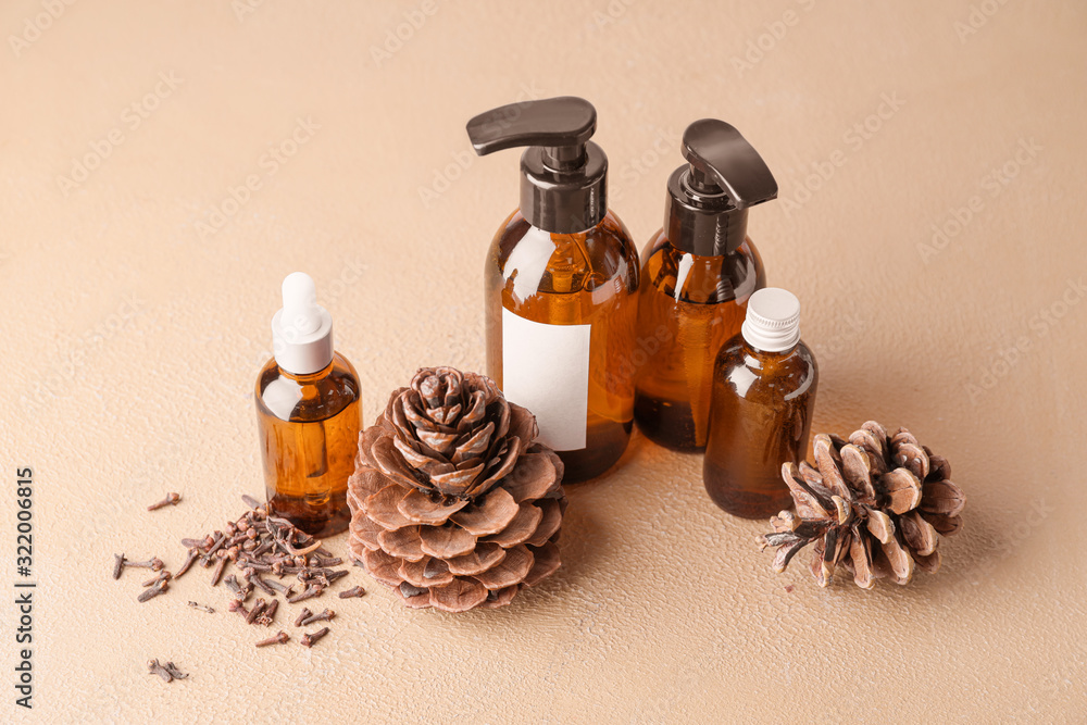 Different cosmetic products in bottles on color background