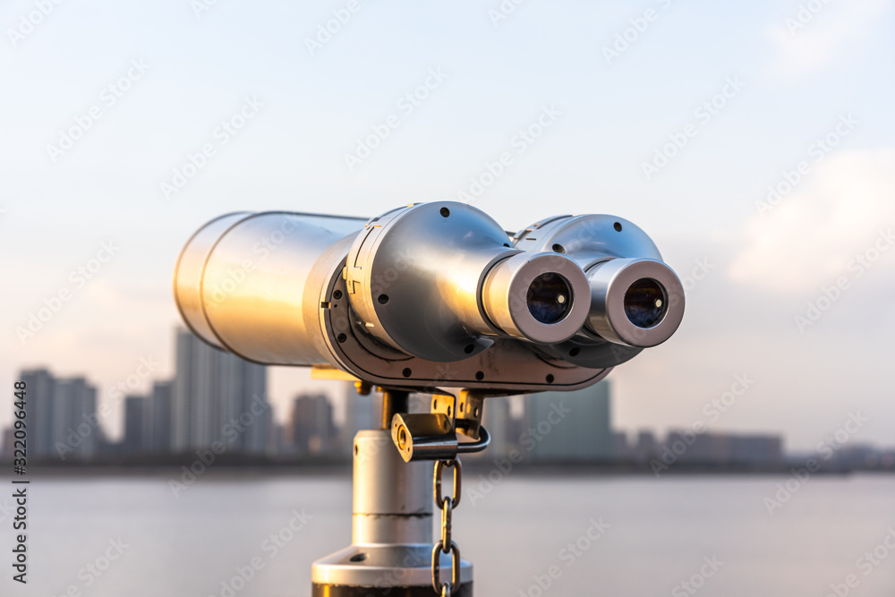 telescope with city skyline