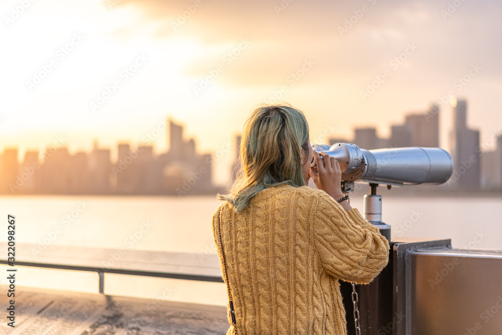 woman looking through binoculars