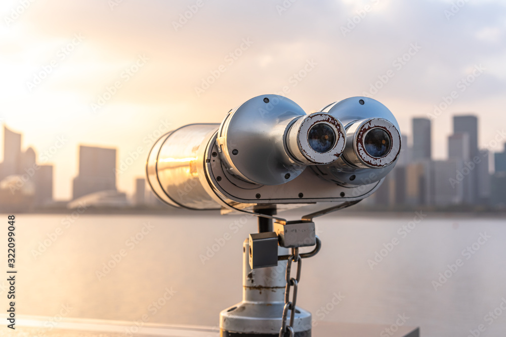 telescope with city skyline