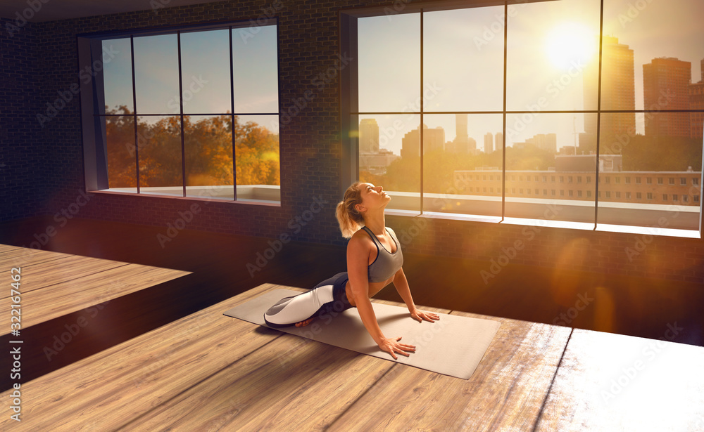 Yoga woman. Young woman doing yoga in loft on sunrise.