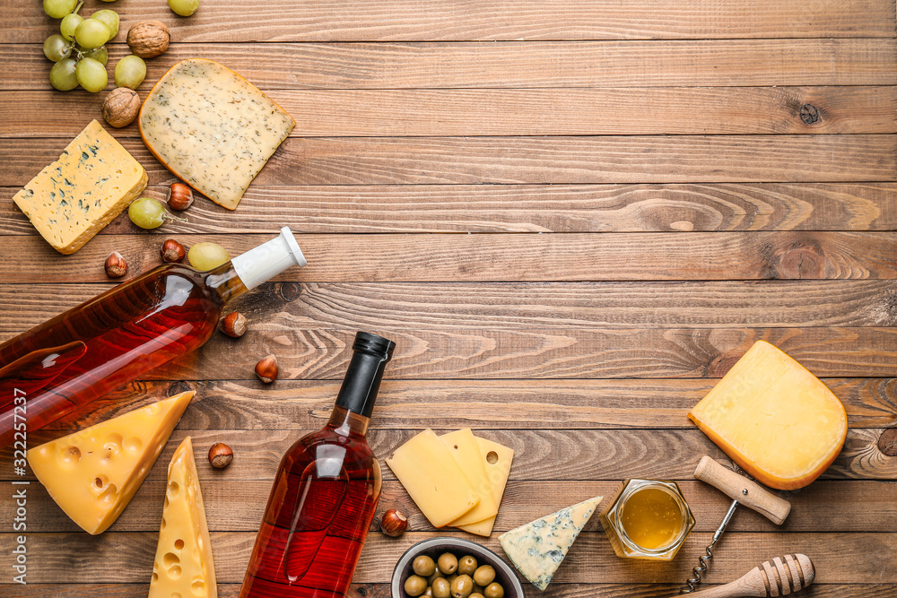 Delicious wine with snacks on wooden background