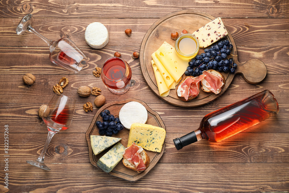 Delicious wine with snacks on wooden background