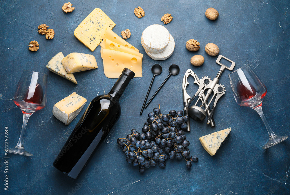 Delicious wine with cheese and nuts on dark background