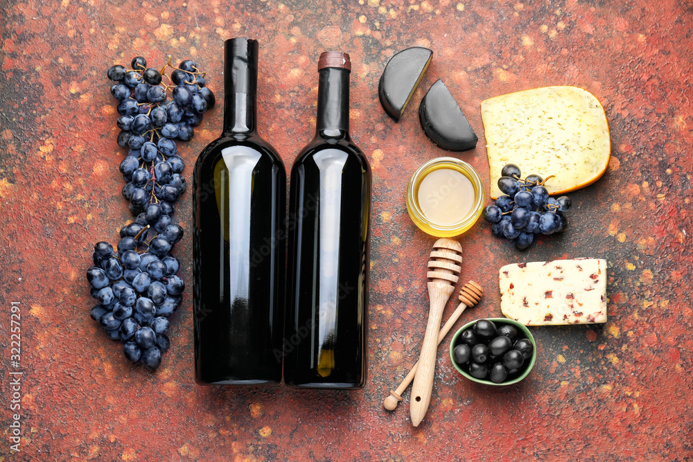 Delicious wine with cheese and honey on color background