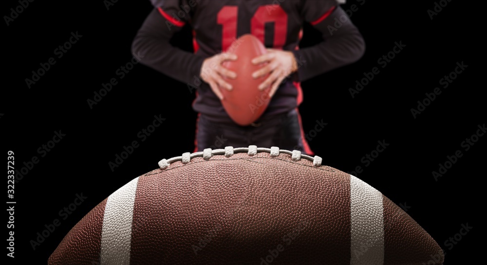 American football ball and player on dark background