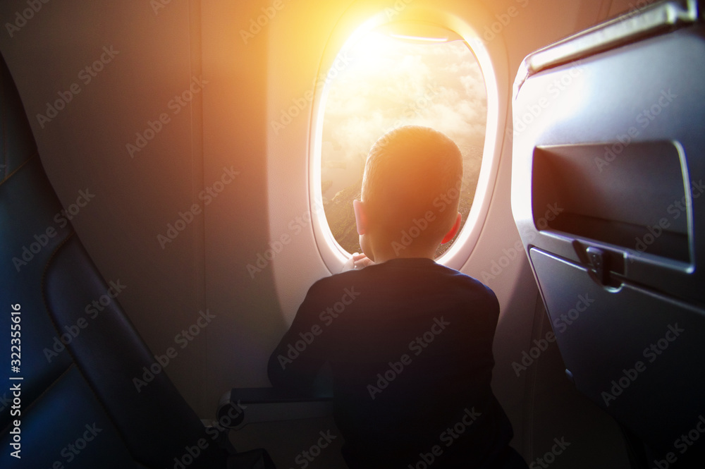 Boy in the plane looking out the window