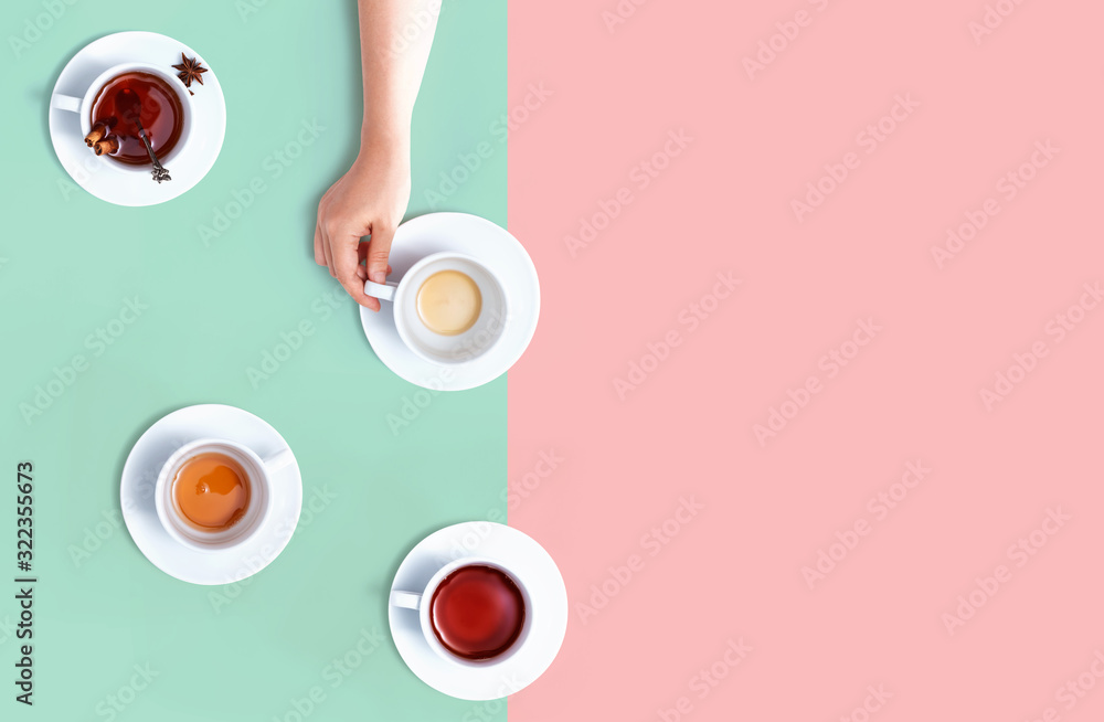 Female hand holding a tea cup overhead view - flat lay