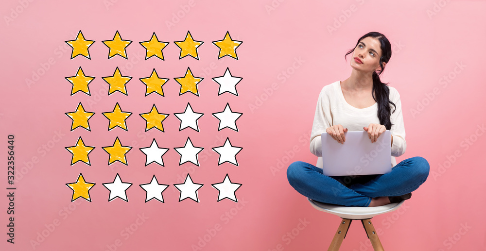 Rating with yellow stars with young woman using a laptop computer