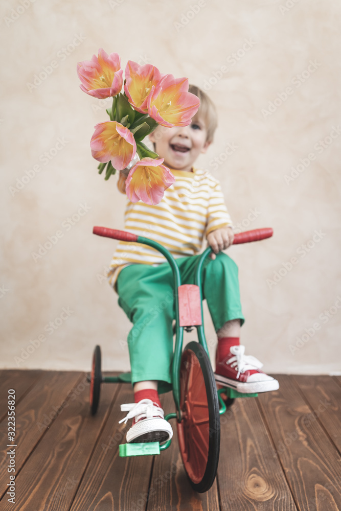 Funny child holding bouquet of flowers