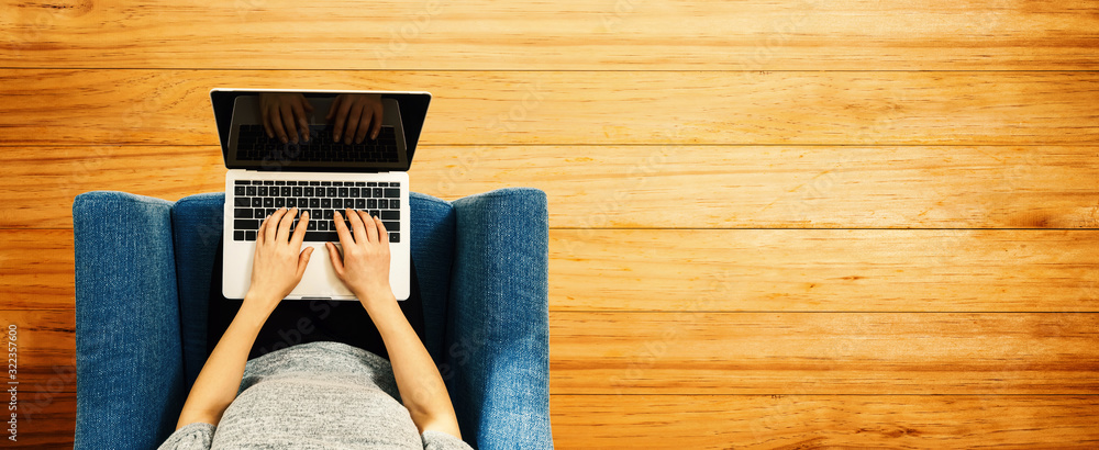 Woman using a laptop computer overhead view