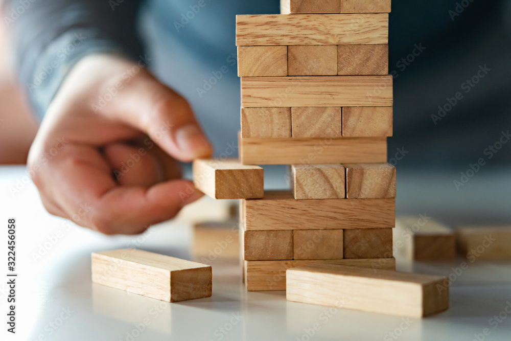 close up of hand businessman playing block wood