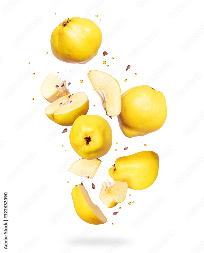 Whole and sliced ​​fresh quince in the air, isolated on white background