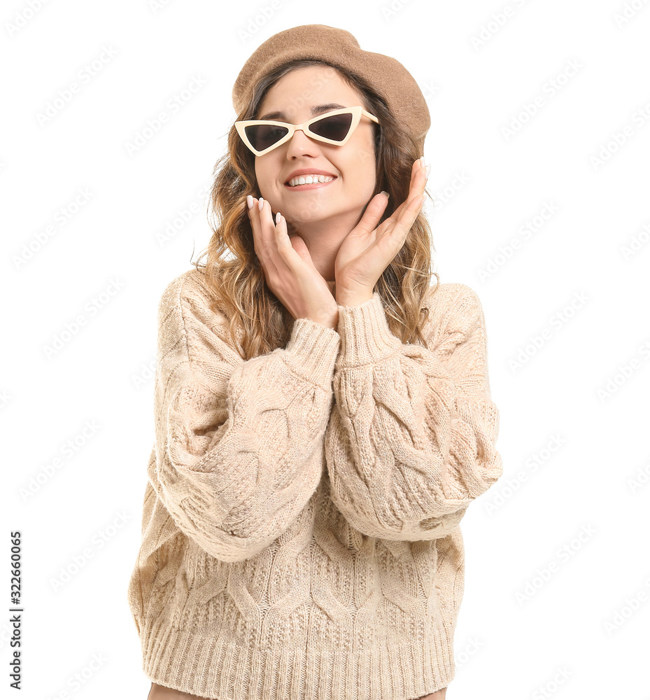 Beautiful young woman in warm sweater on white background