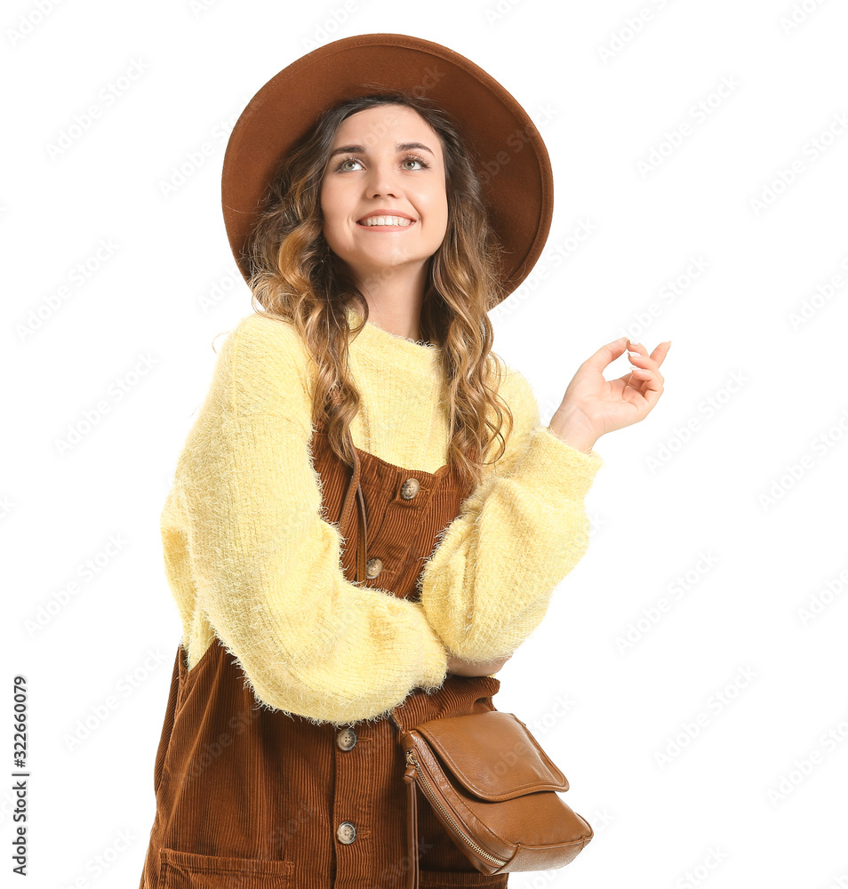 Beautiful young woman in warm sweater on white background