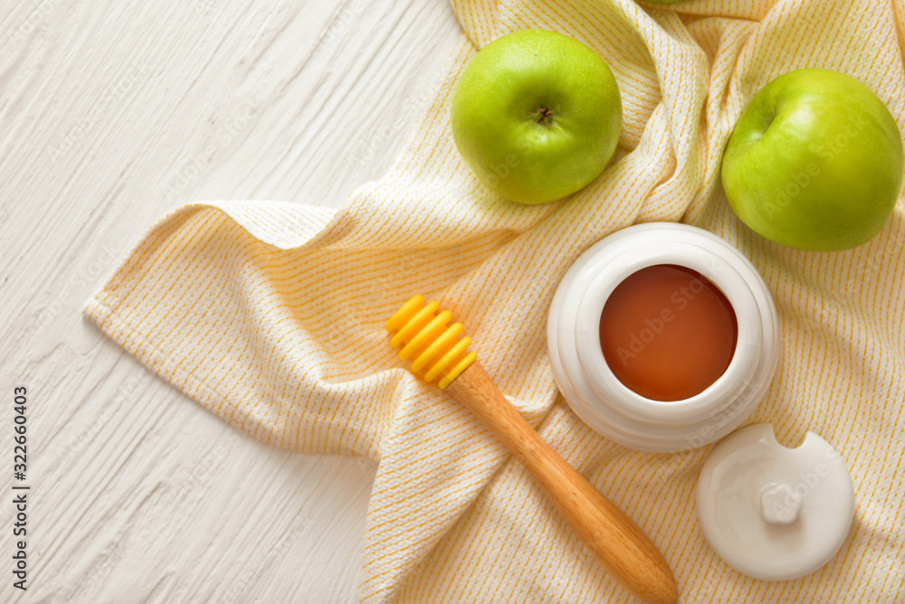 Sweet honey and apples on table