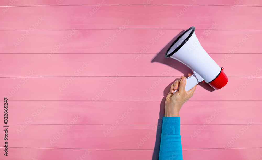 Person holding a megaphone with hard shadow