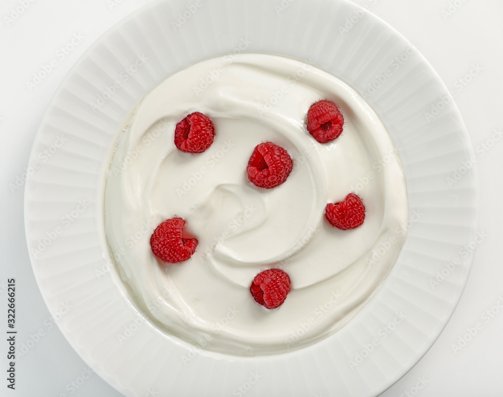 plate of greek yogurt with raspberries