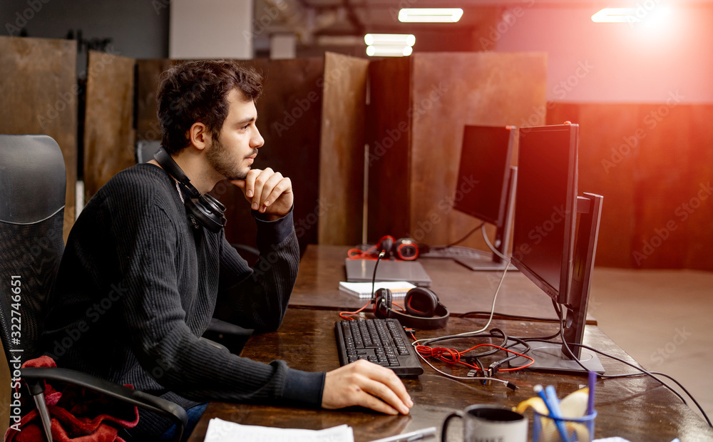 Computer programmer writing program code on computer in office. Programming.