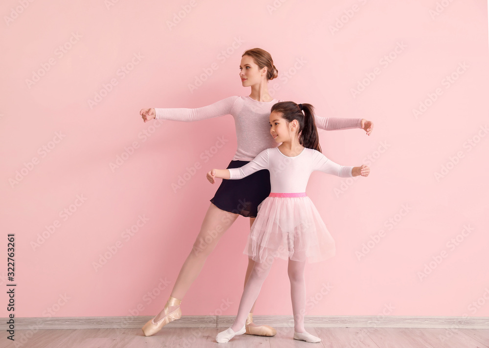 Little ballerina training with coach against color background