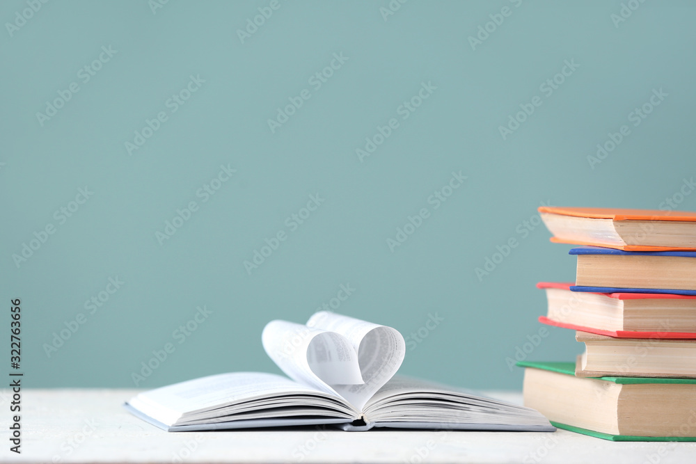 Heart shape made of book pages on table