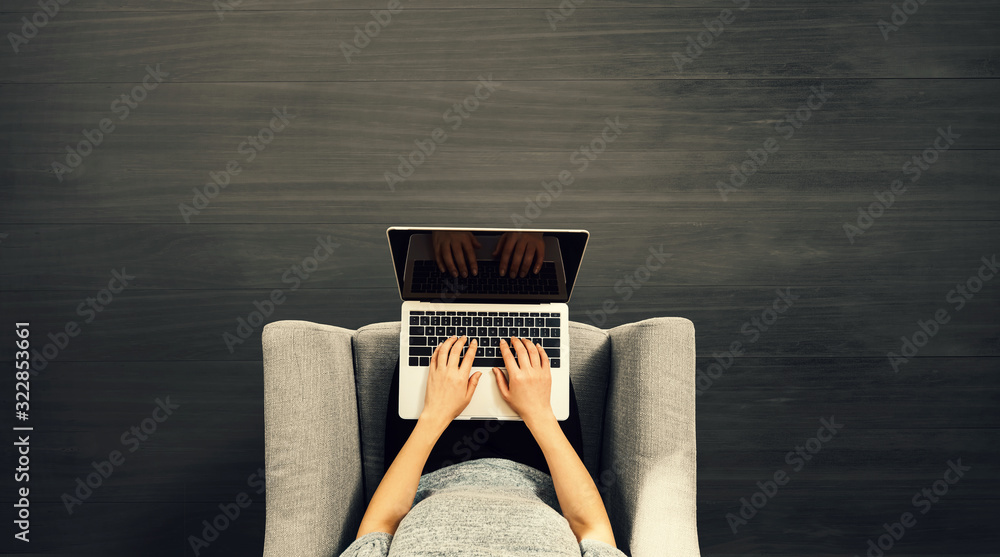 Woman using a laptop computer overhead view