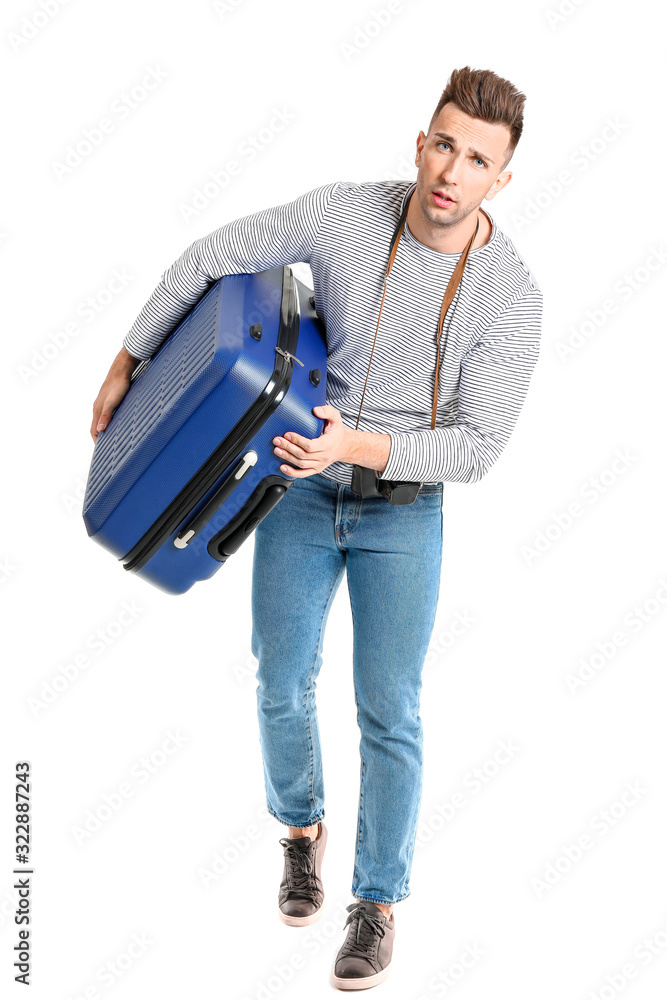 Male tourist with luggage on white background