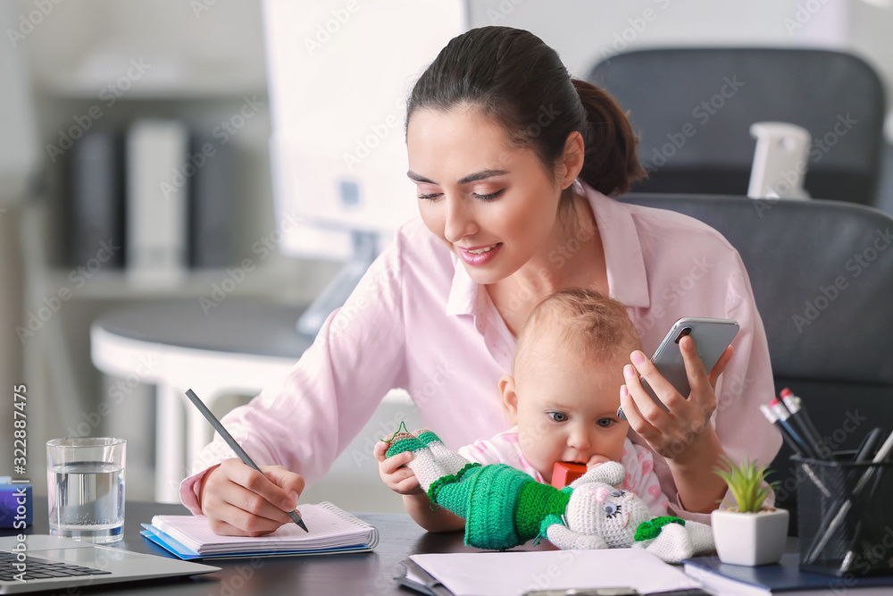 Working mother with her baby in office