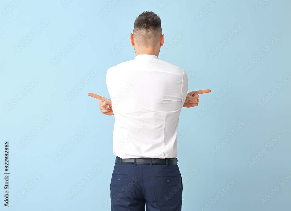 Businessman pointing in different directions on color background. Concept of choice