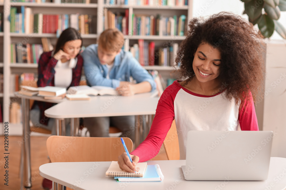 African-American student preparing for exam in library