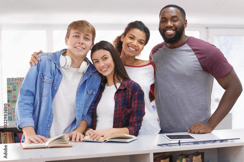 Group of young students in library