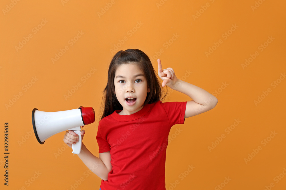 Cute little girl with megaphone and raised index finger on color background