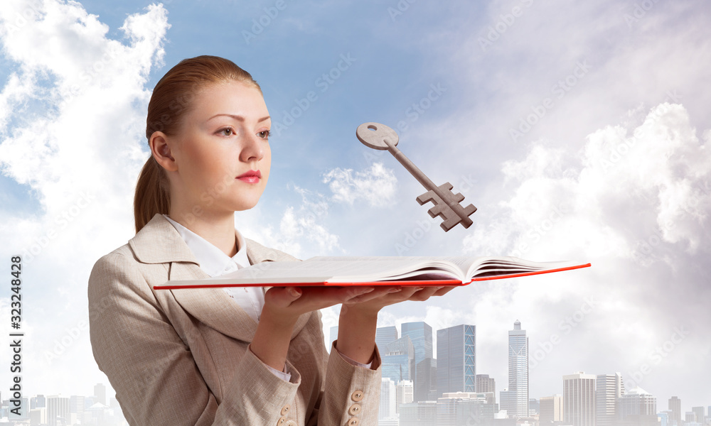 Woman looks at flying big metal key