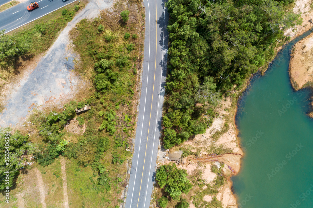 Asphalt road curve with yellow line on road image by drone camera high angle view.