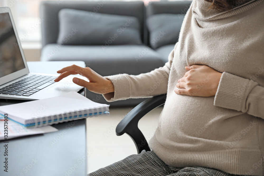 Pregnant businesswoman working in office